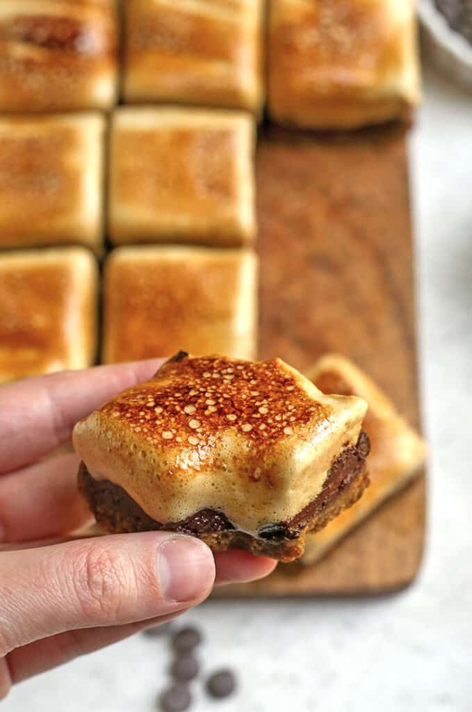 hand holding a paleo s'more cookie bars with a bite taken out of it