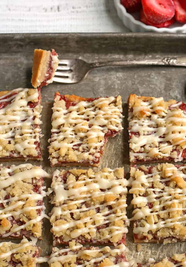 paleo strawberry crumb bars, cut on a pan