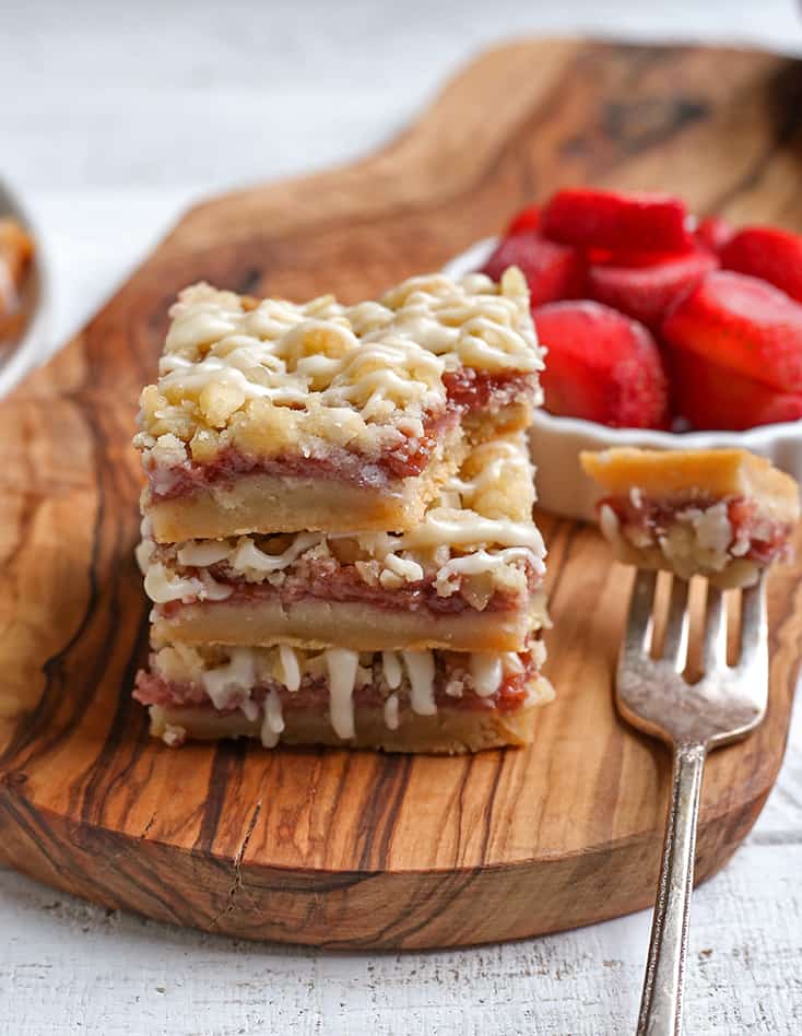 stack of strawberry crumb bars with a bite taken out of one