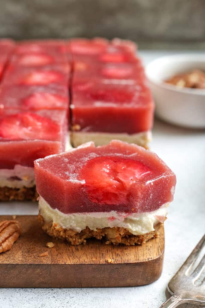 piece of grain free strawberry pretzel salad with a bite taken out 