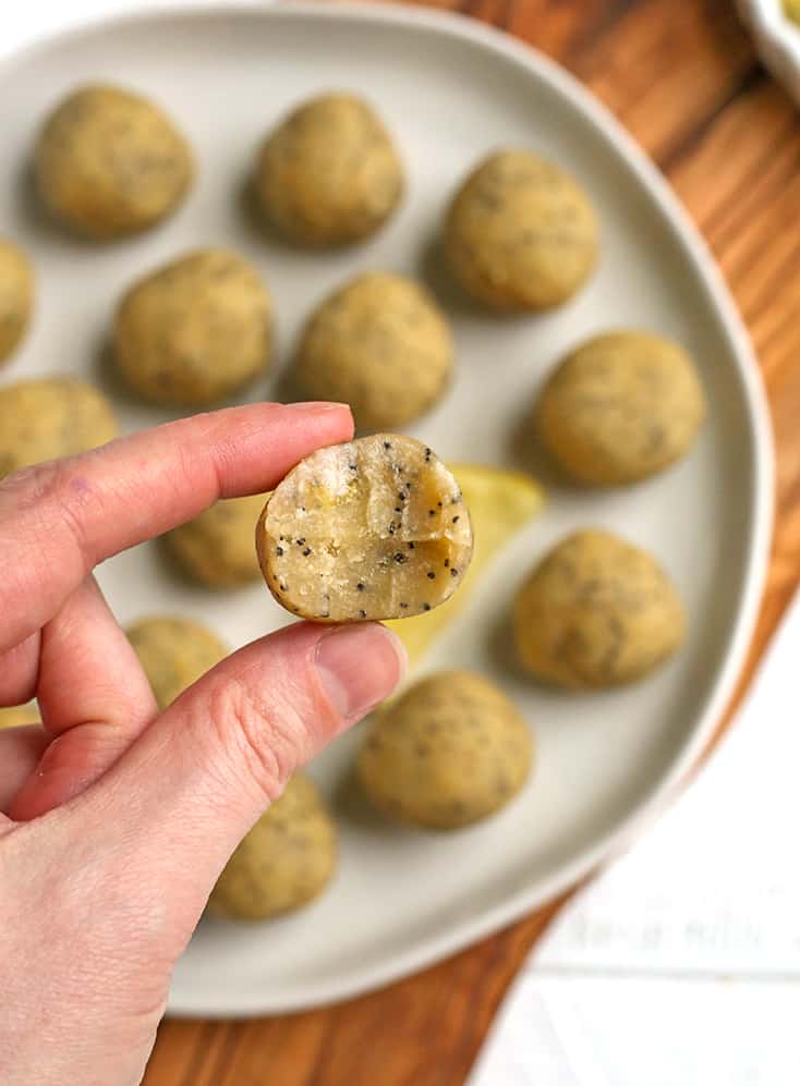 hand holding a vegan paleo lemon poppy seed bite