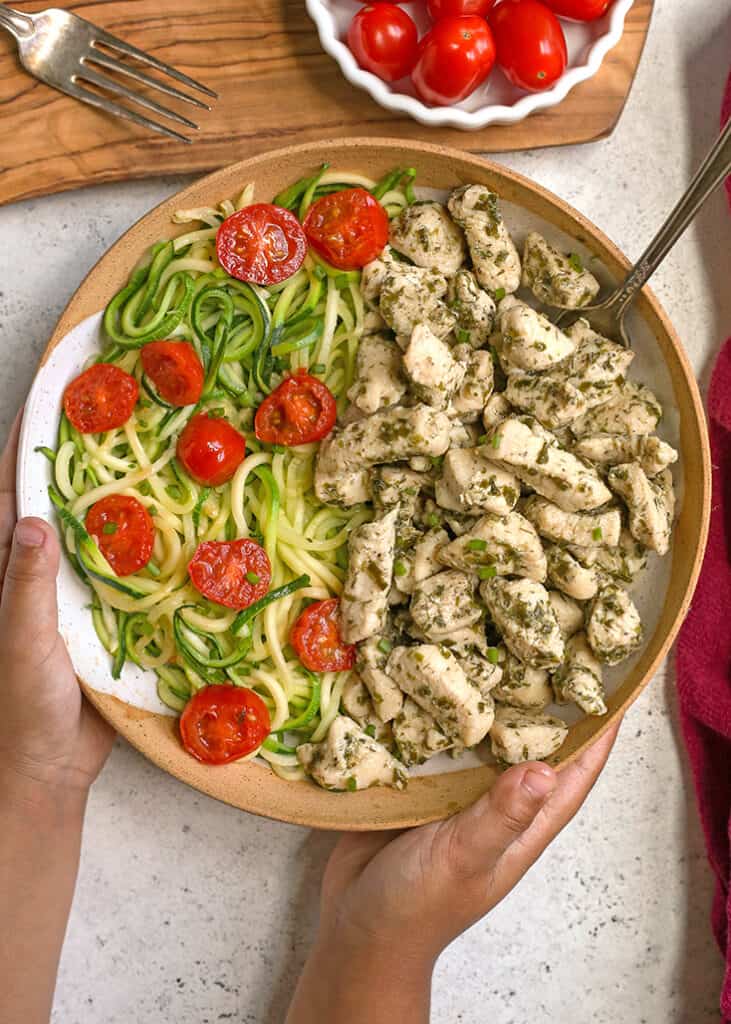 little hands holding a bowl of paleo ranch chicken bites