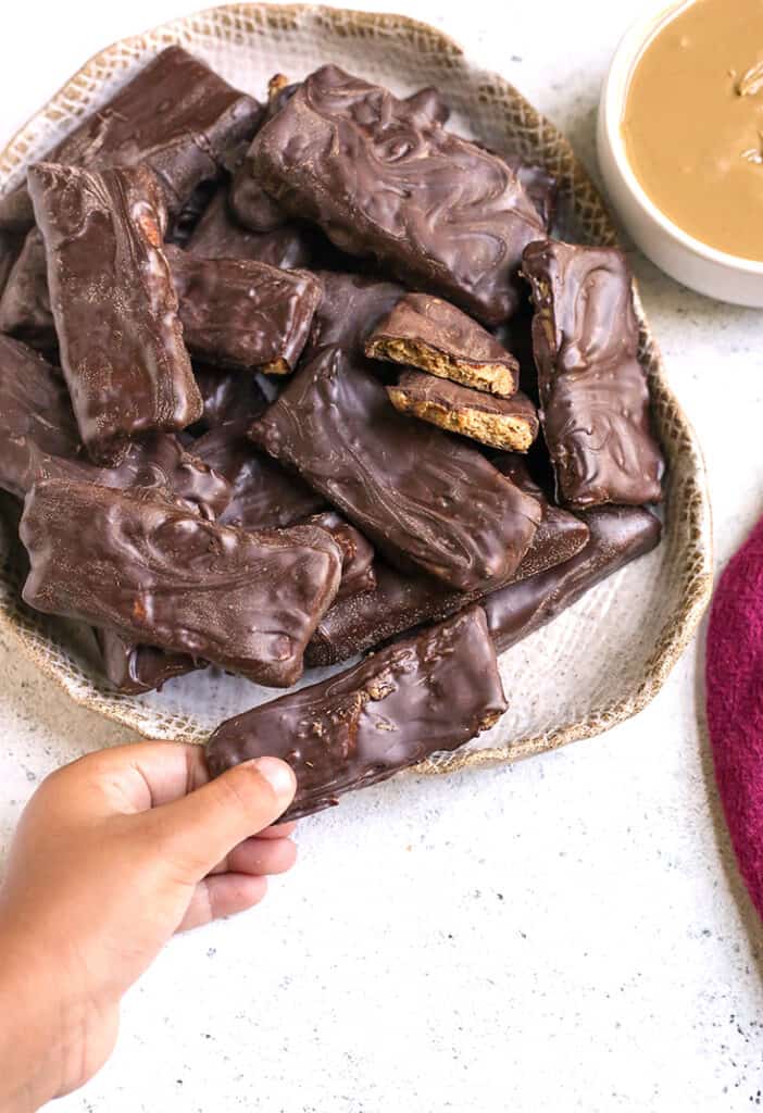 a little hand grabbing a paleo vegan Butterfinger candy bar