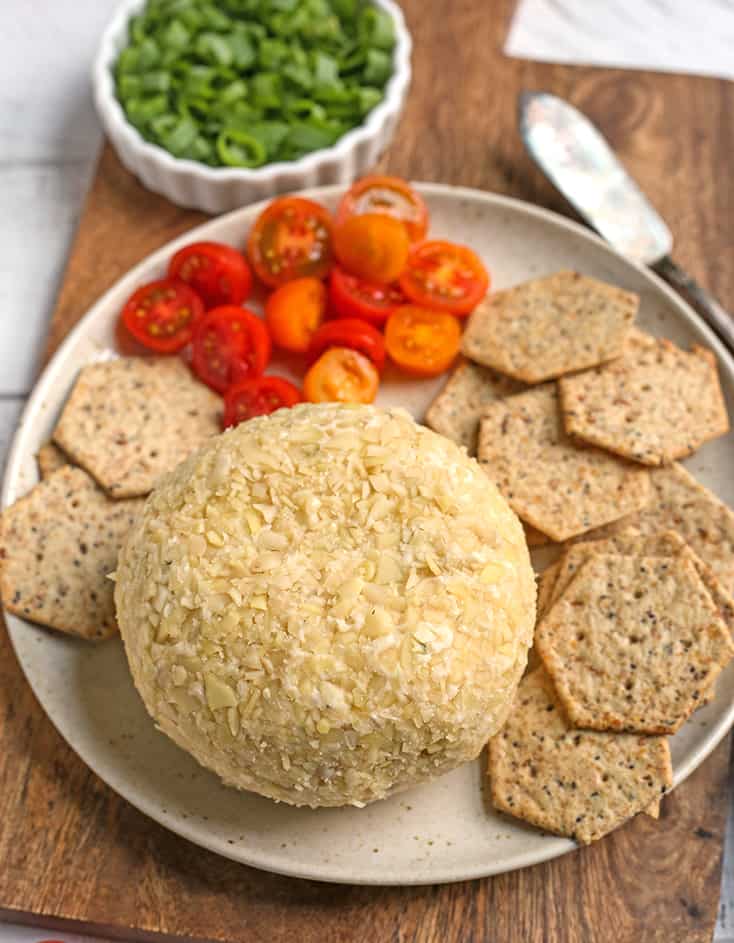 vegan paleo cheeseball on a plate with crackers