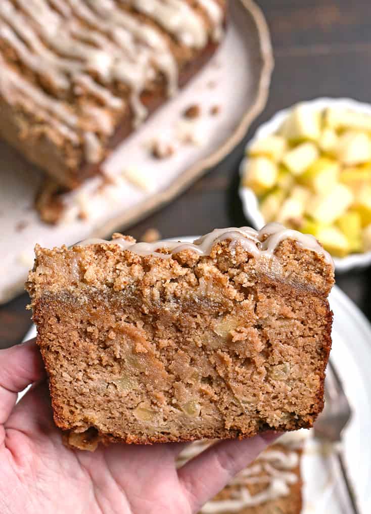 hand holding a piece of paleo apple pie crumb bread