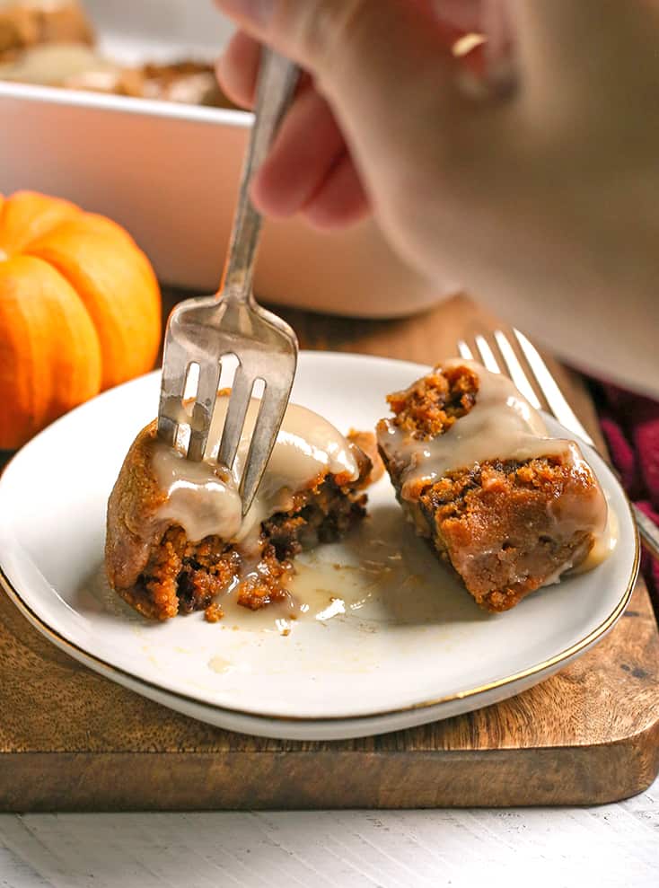a fork taking a bite of a paleo pumpkin cinnamon roll 