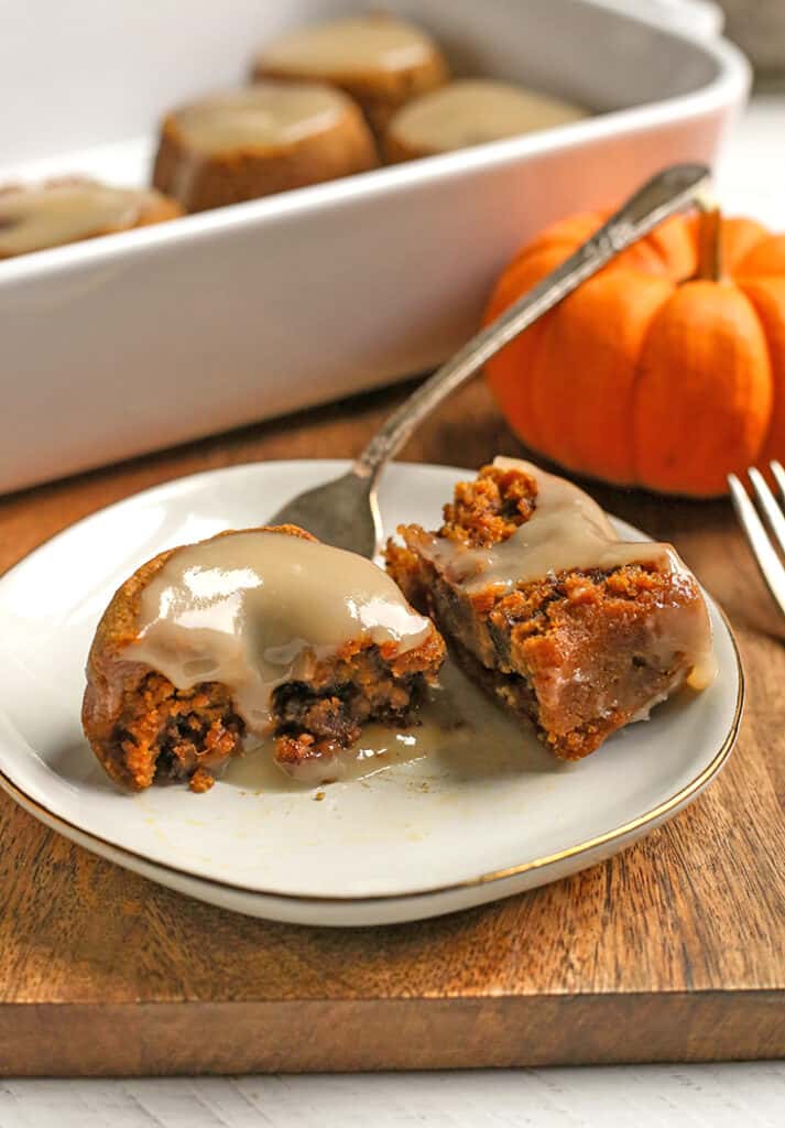 paleo pumpkin cinnamon roll on a plate, cut in half