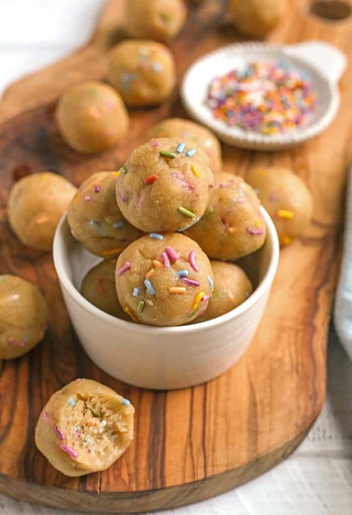 a cutting board with paleo vegan birthday cake bites on it