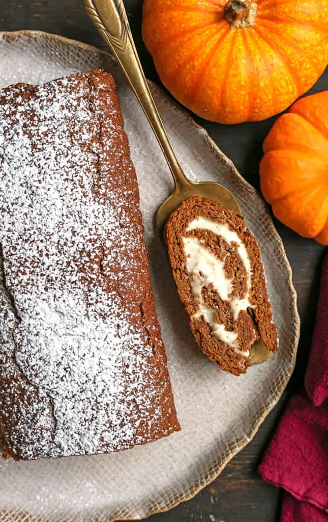 a slice of paleo pumpkin roll on a pie server