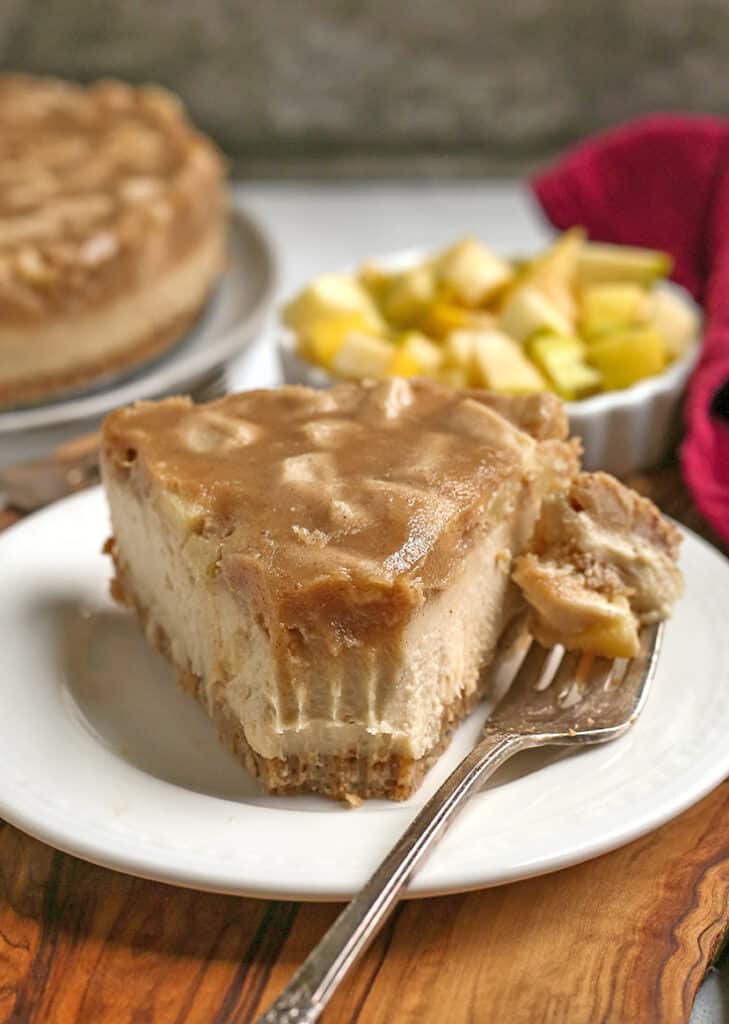 a piece of paleo vegan caramel apple cheesecake on a plate 