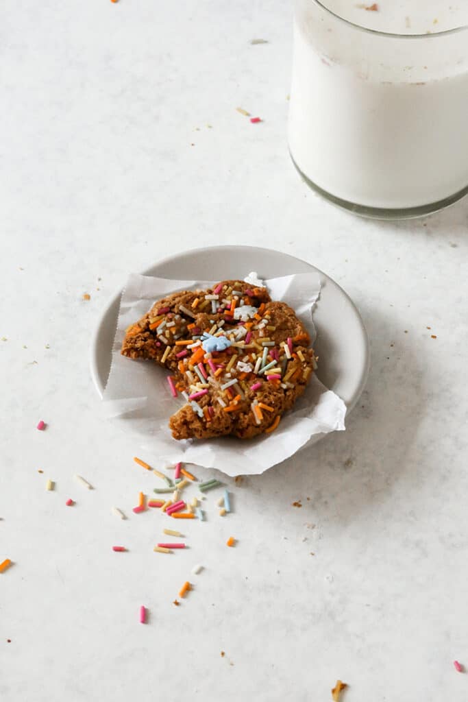 paleo sprinkle cookie on a little plate with a bite taken out 
