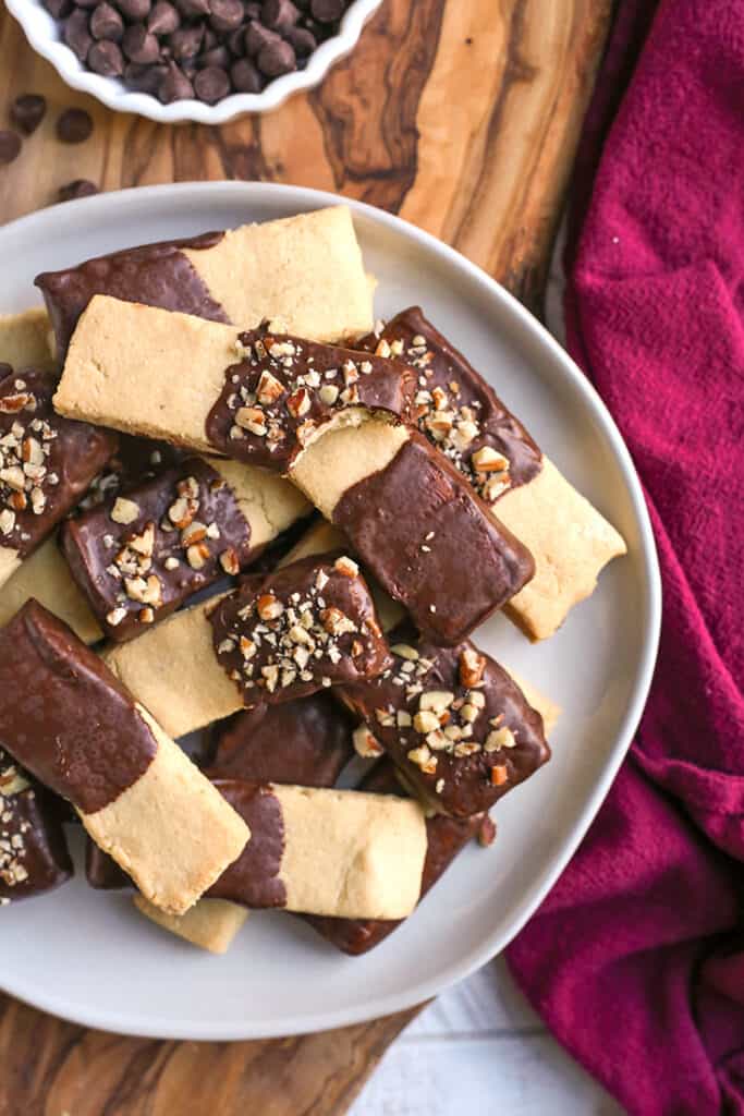 chocolate dipped grain free shortbread cookies stacked on a plate