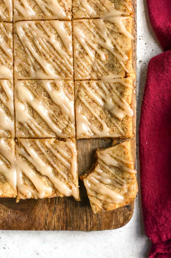 top view of pale cinnamon roll blondies. Drizzle on top and cut into squares 