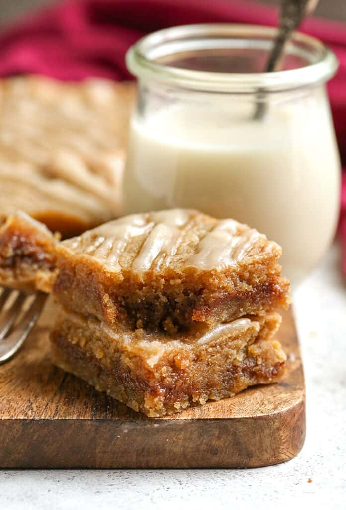 two cinnamon roll blondies with a bite taken out of the top one