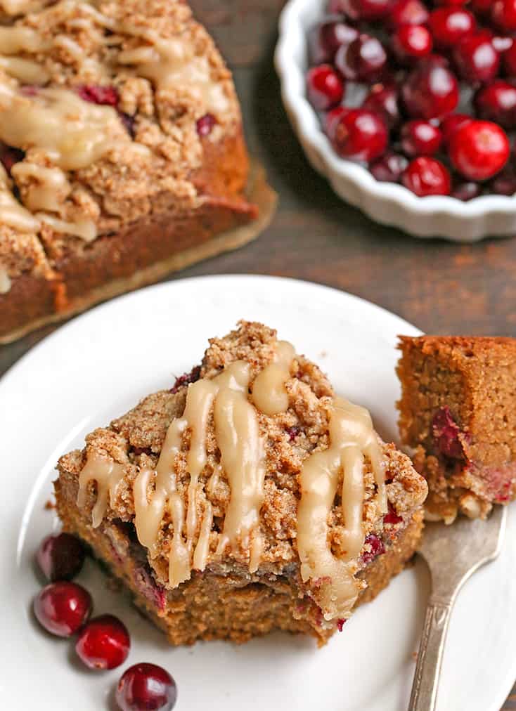 paleo cranberry coffee cake with a bite taken out 