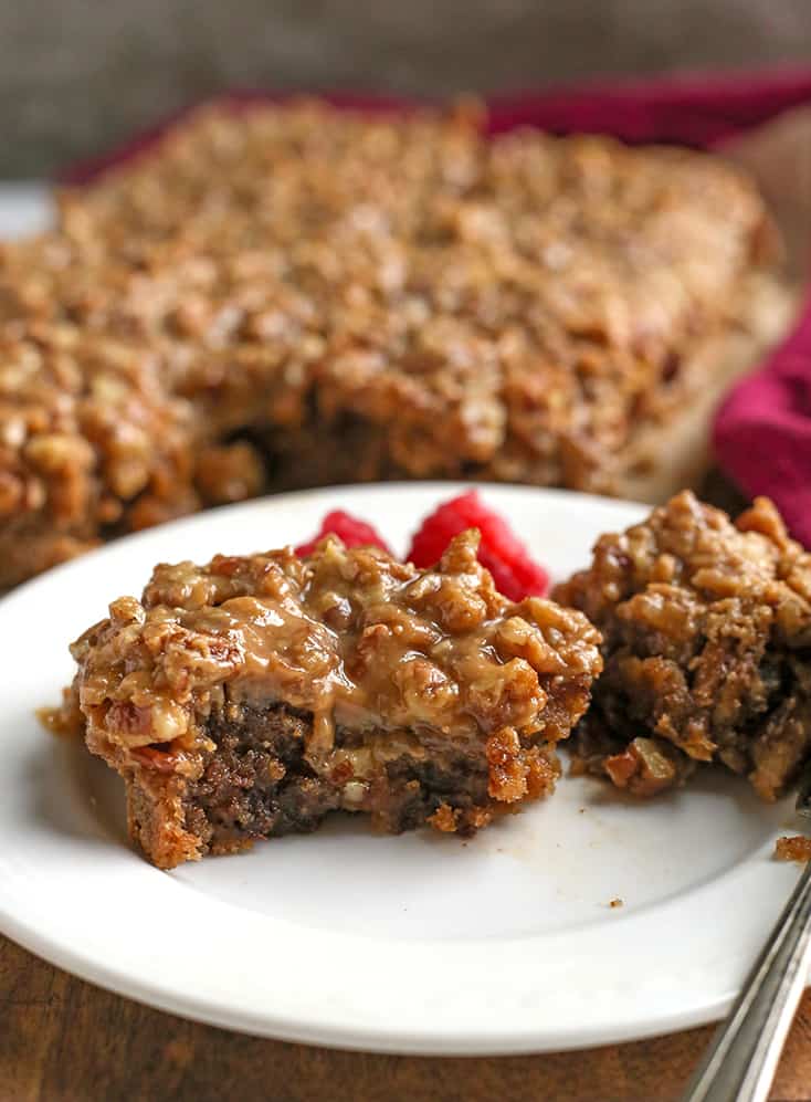 paleo pecan sticky bun on a plate with a bite taken out 