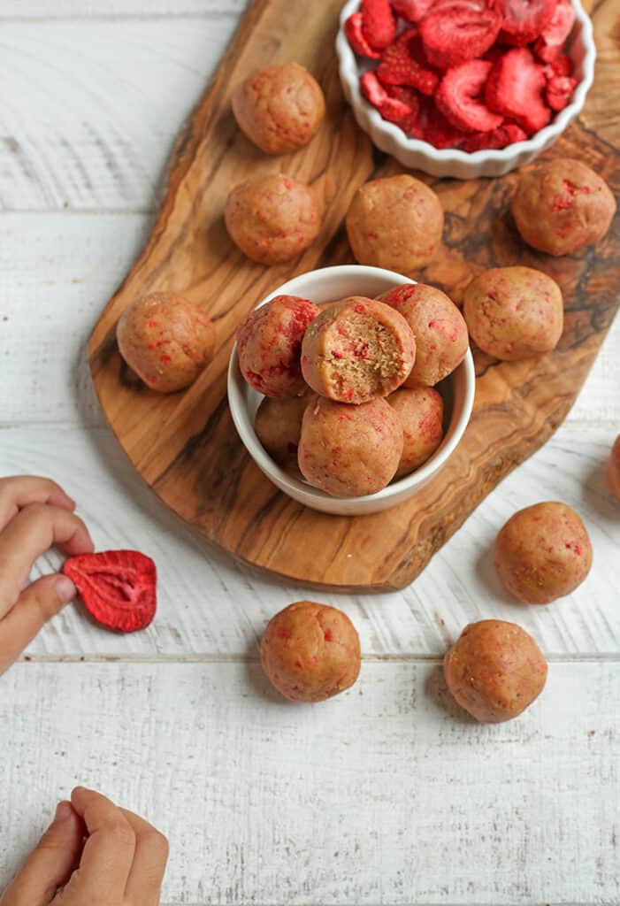 little hands in the picture with the vegan paleo strawberry shortcake bites 