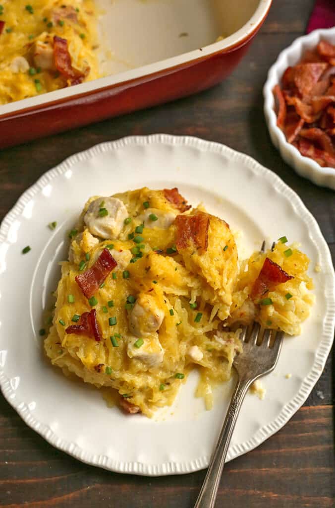 a serving of paleo bacon chicken ranch casserole on a plate with a fork taking a bite