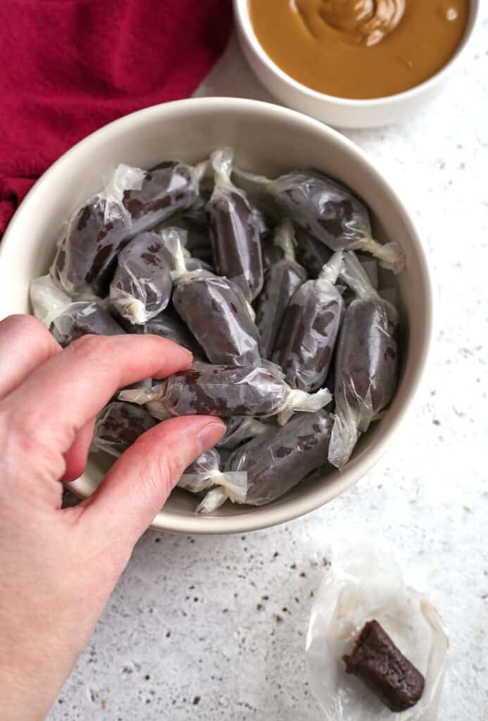 a hand reaching for a paleo vegan tootsie roll