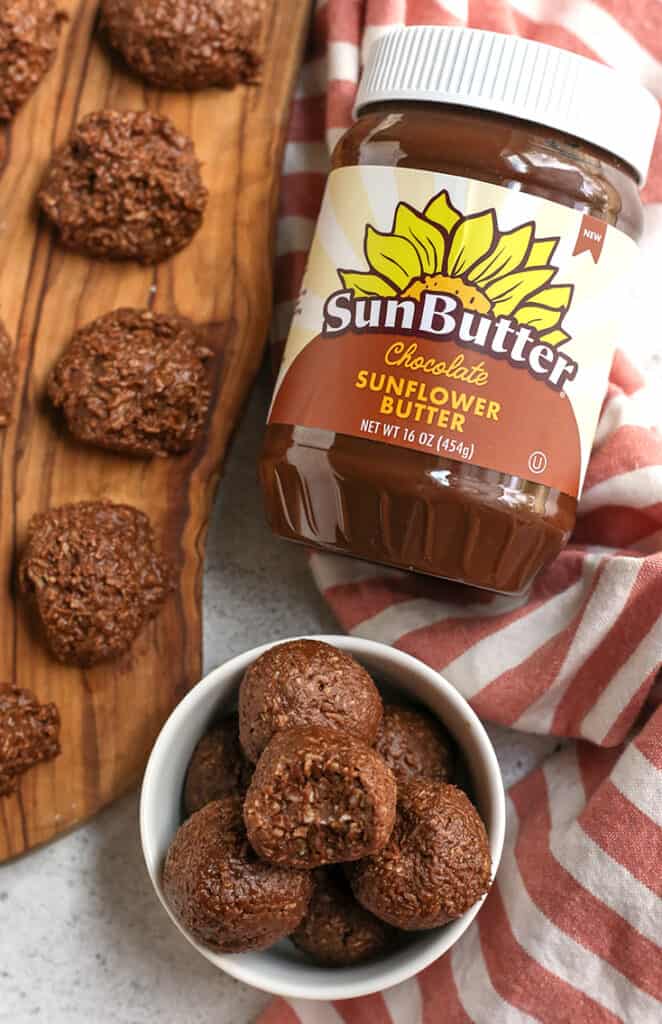 paleo nut free chocolate coconut bites in a bowl and on a cutting board 