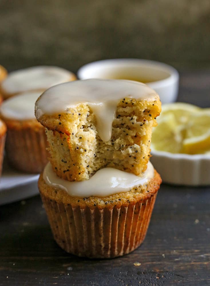 a stack of two lemon poppy seed muffins with glaze 