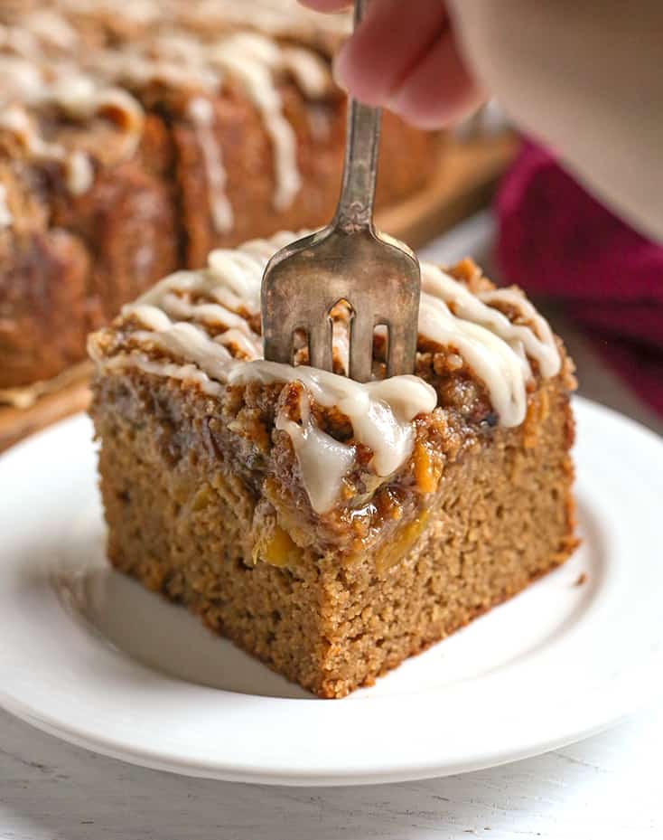 a fork taking a bite of paleo peach cobbler coffee cake 