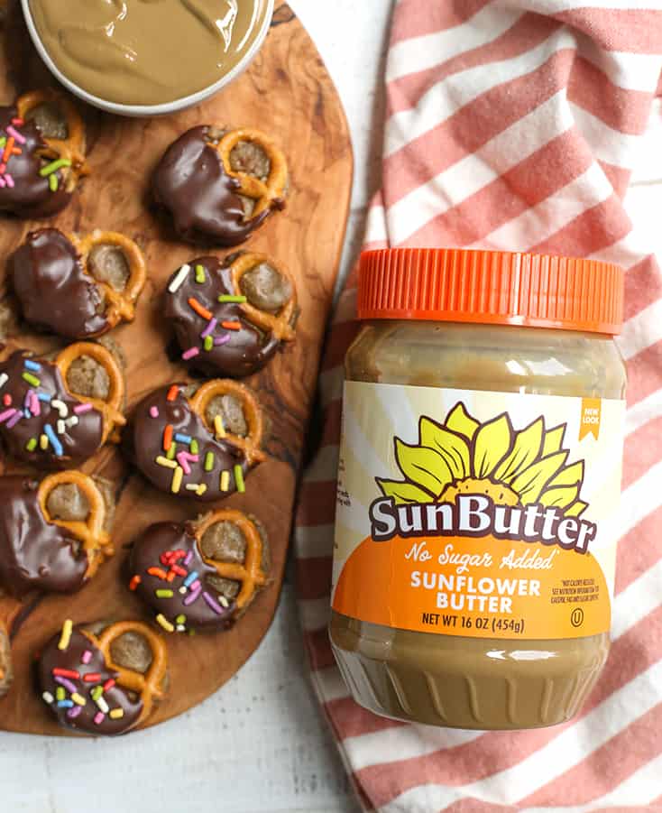 a jar of sunbutter with pretzel bites next to it 