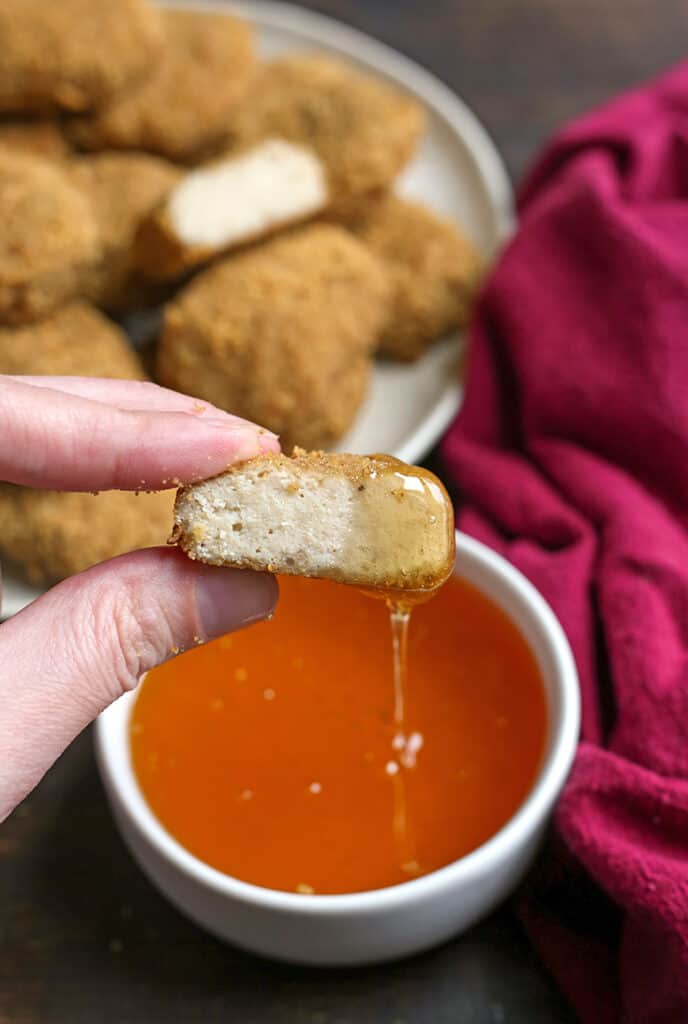 a paleo chicken nugget cut in half dup in a bowl oh honey