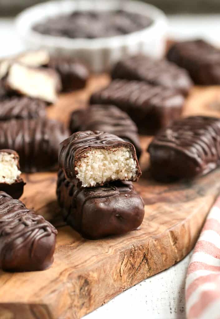 paleo vegan mounds on a cutting board, one cut and stacked on another 