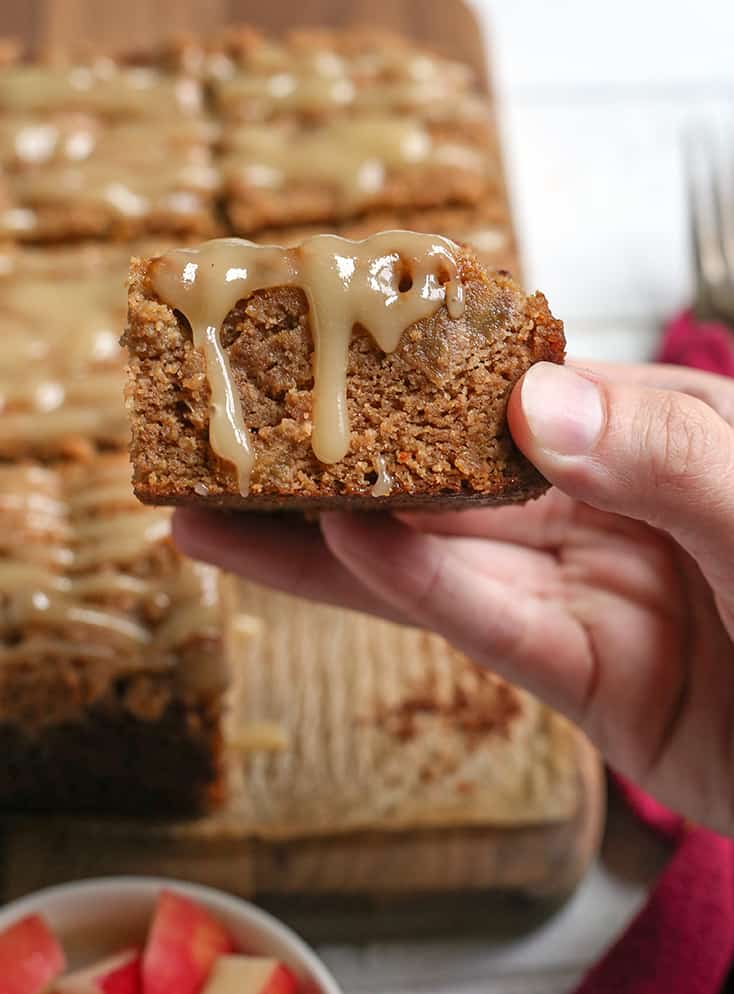 hand holding a piece of paleo apple crisp coffee cake