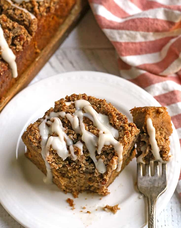 a piece of paleo sweet potato pecan coffee cake on a plate with a bite taken out 