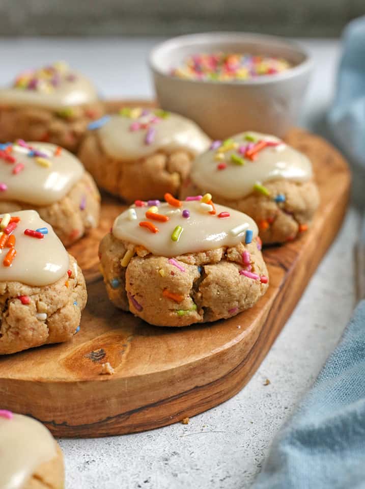 paleo birthday cake cookies on a wooden cutting board 