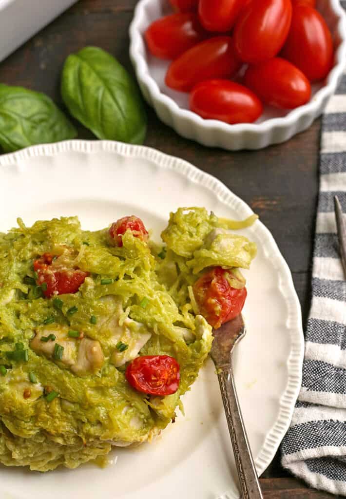 a close up of a plate with paleo pesto casserole with a bite taken out of it 