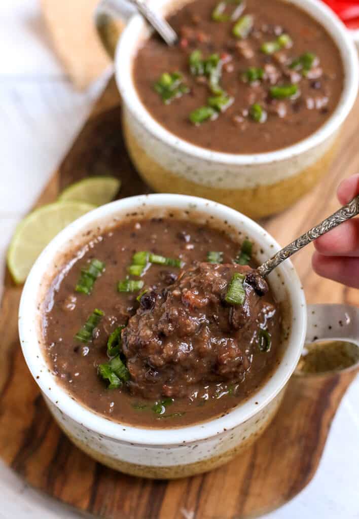 a bite being taken of gluten free black bean soup 