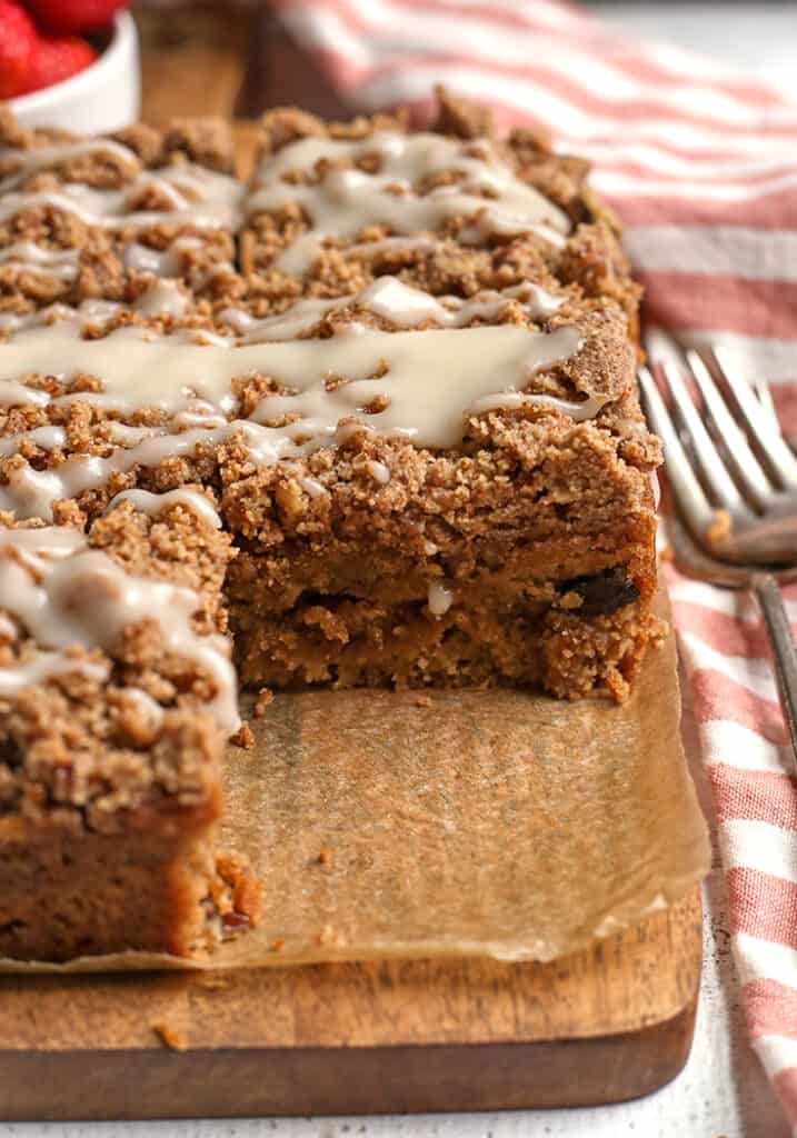 sour cream coffee cake on a cutting board with a slice removed