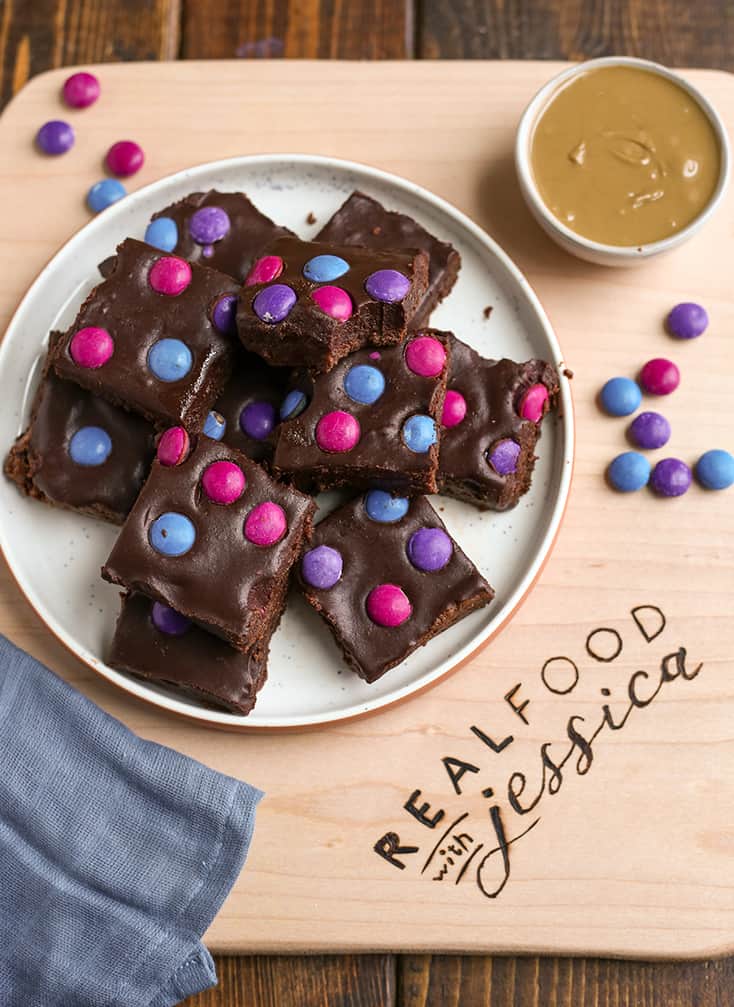 a plate of paleo vegan cosmic brownies sitting on a cutting board 
