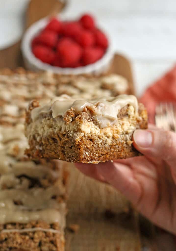 hand holding a piece of gluten free cheesecake coffee cake with the layers showing 