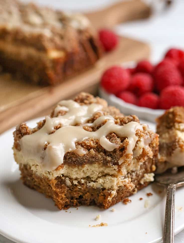 piece of cream cheese coffee cake on  a small plate with a bite taken out 