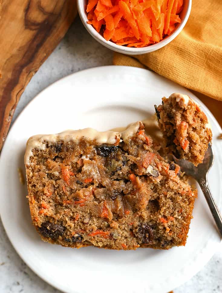 a bite taken out of paleo carrot cake loaf 