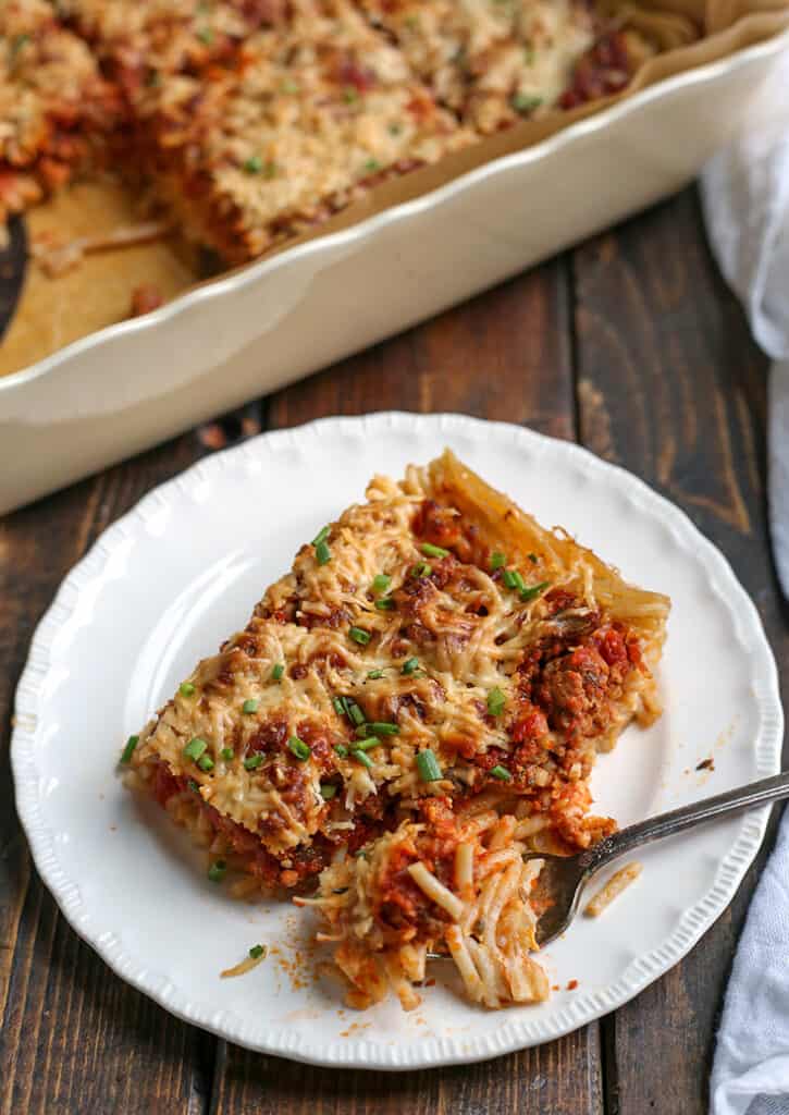 piece of gluten free spaghetti pie on a plate with bite on the fork 