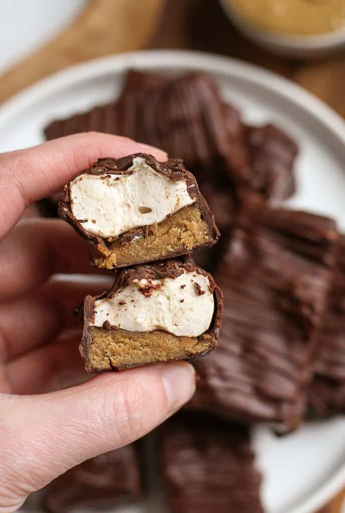 hand holding a stack of healthy paleo candy bars