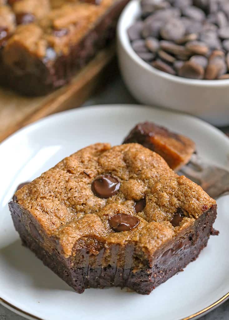 paleo gluten free cookie brownie on  a plate with a bite taken out 