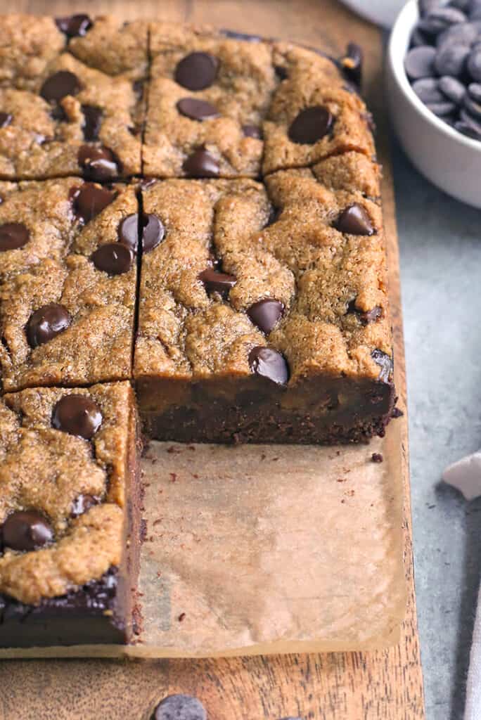 paleo cookie brownies on a cutting board with one missing so inside shows 