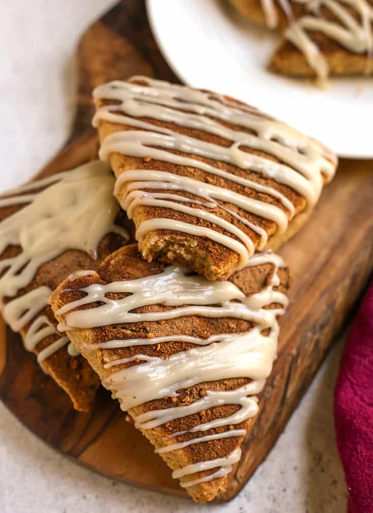 stack of paleo cinnamon roll scones on a cutting board 