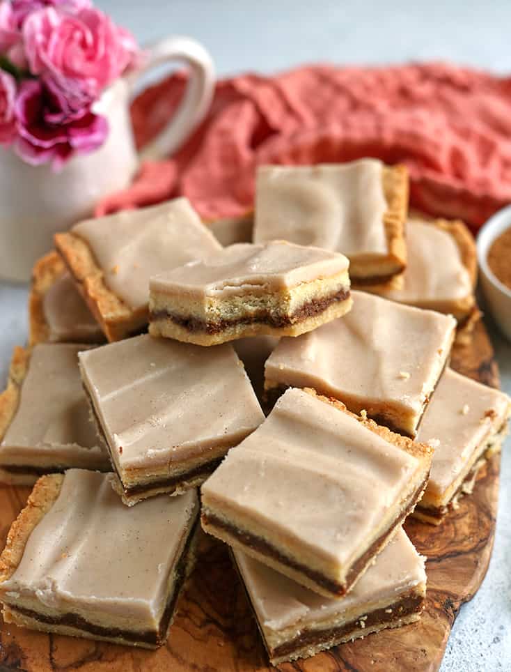 brown sugar pop tart bars stacked on a wooden cutting board