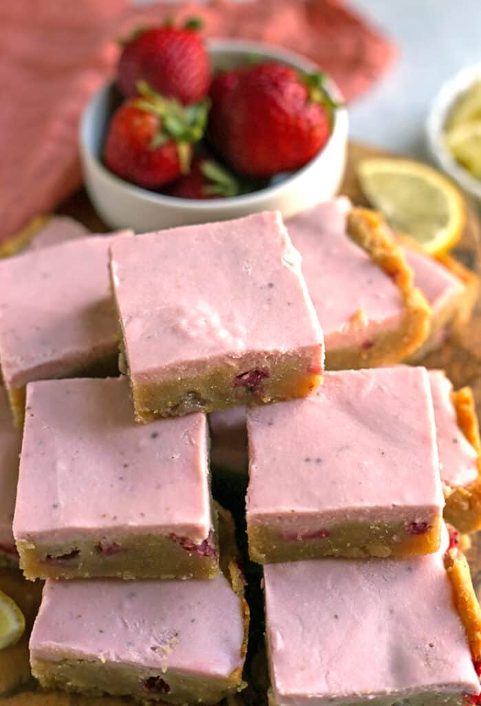 stack of paleo strawberry lemon bars on a cutting board 