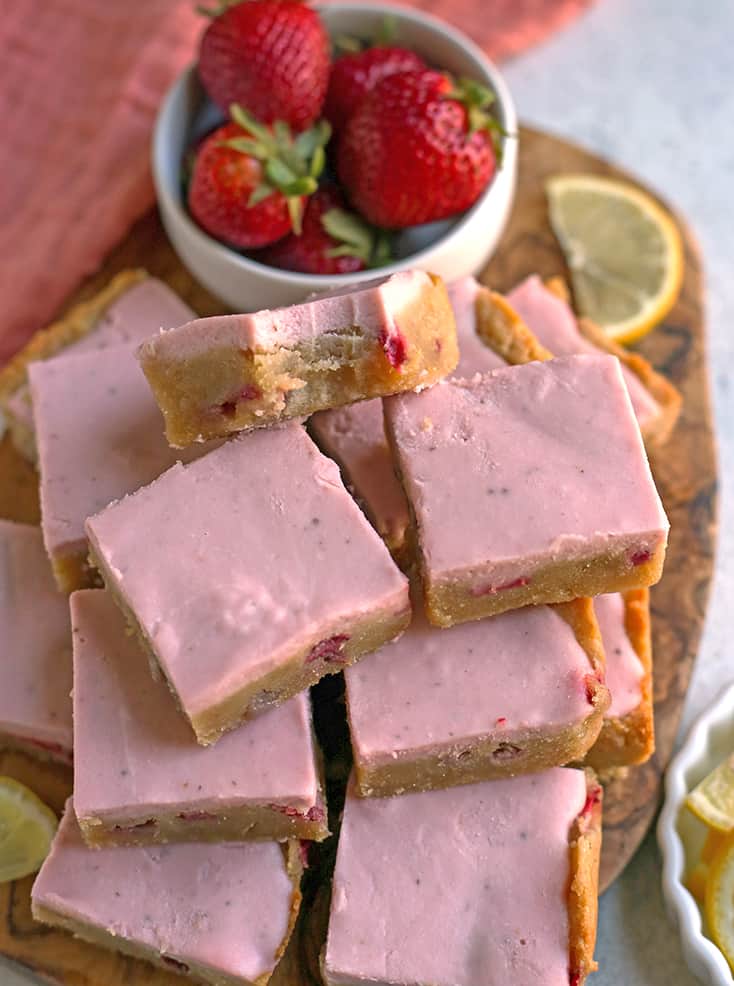 close up of vegan strawberry lemon bars with a bite taken out of one 