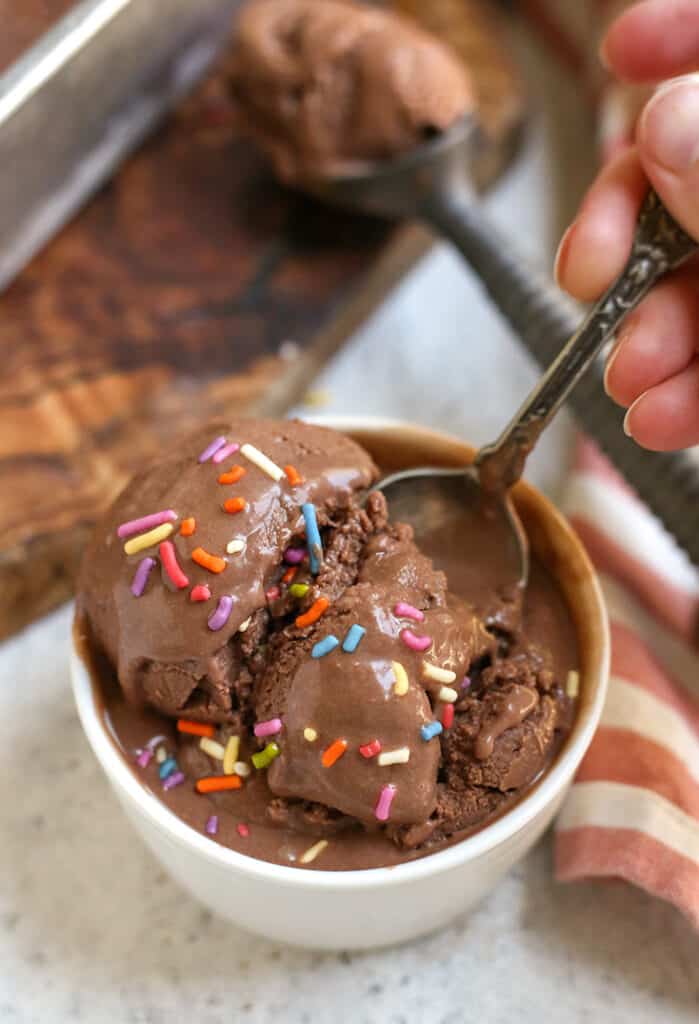 spoon taking a bite of vegan creamy chocolate ice cream