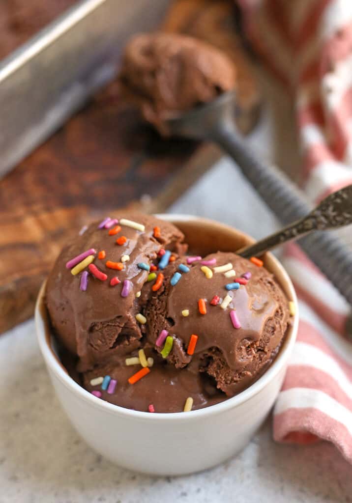 creamy chocolate ice cream in a bowl with sprinkles on top 
