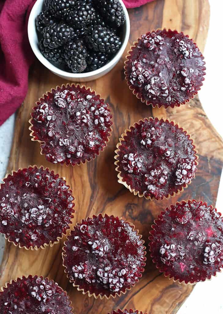 top view of goat cheese cheesecake muffins showing the blackberry topping 